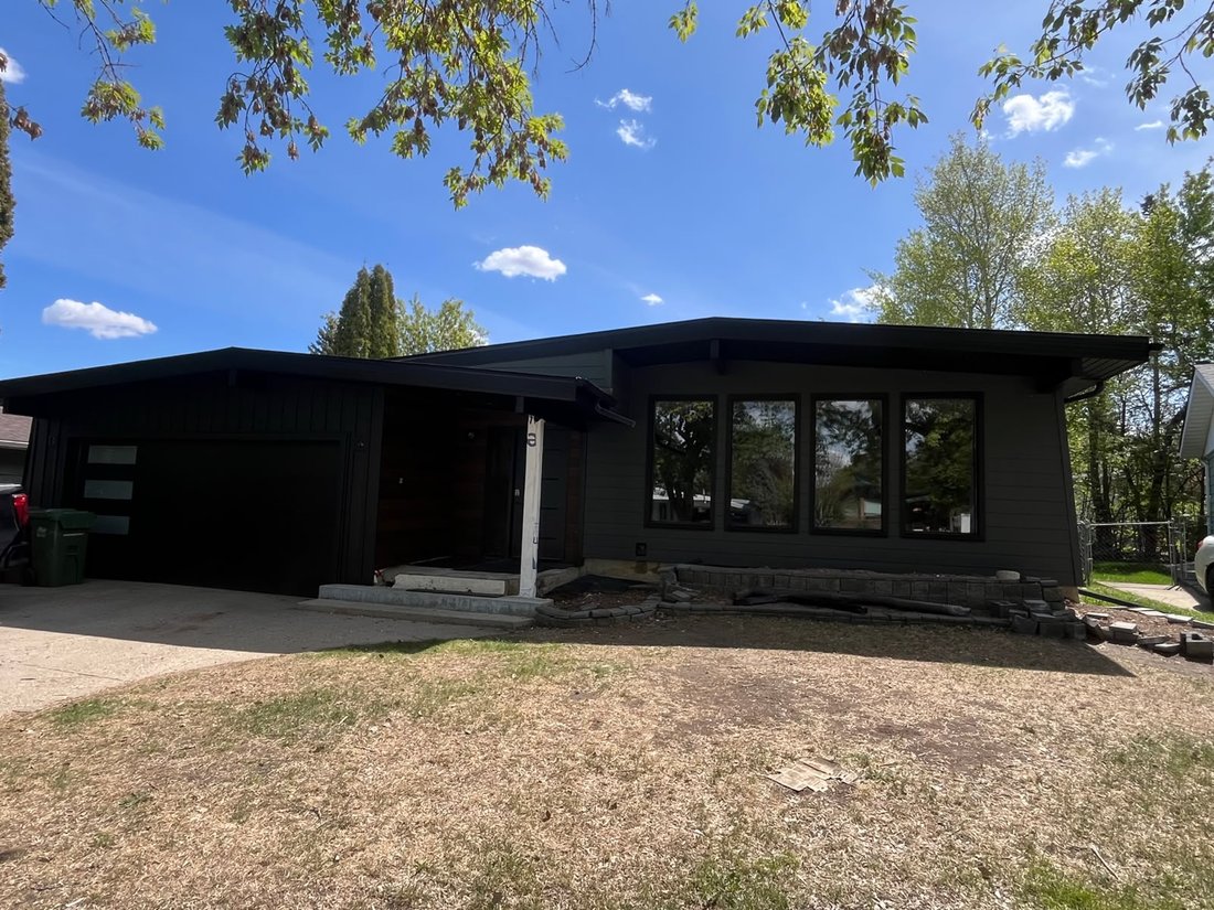 Bungalow after full re-side with dark modern siding