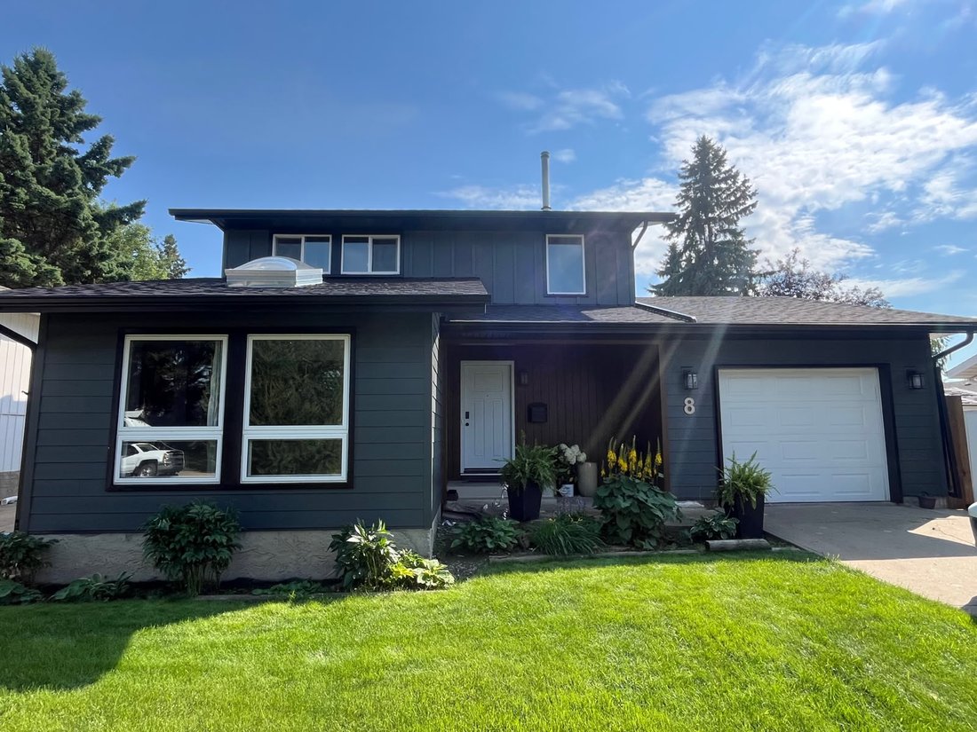 Home after full re-side with dark vertical siding