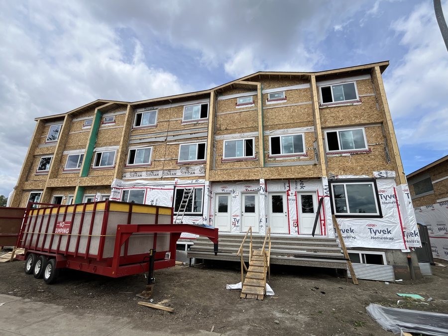 Same multi-unit building wrapped in house wrap before siding